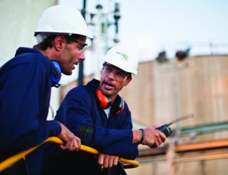 People in safety gear talking