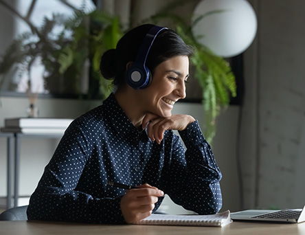 Person with headphones looking at laptop